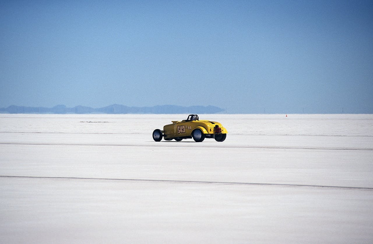Vintage yellow hot rod racing on the Bonneville Salt Flats. High speed adventure.