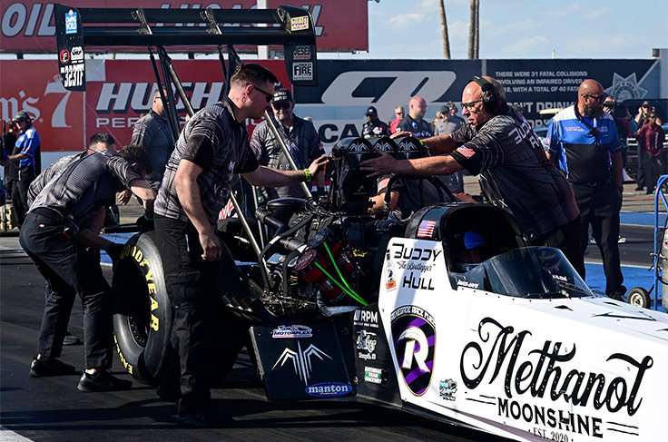 NHRA pit crew working on a Top Fuel dragster between qualifying runs at a 2026 NHRA event