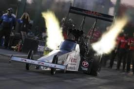 NHRA Funny Car burnout before a qualifying run at a national event — wide angle grandstand view