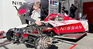 Formula E team garage and pit lane operations — electric race car preparation during a 2026 ePrix weekend