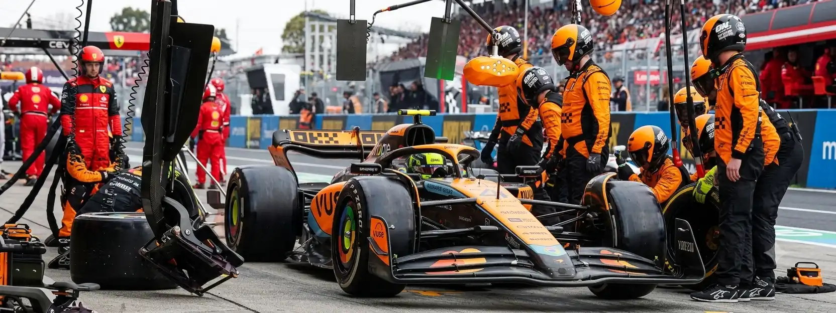 Open-wheel race car pit stop in progress β mandatory four-tyre stop defines Super Formula 2026 race strategy