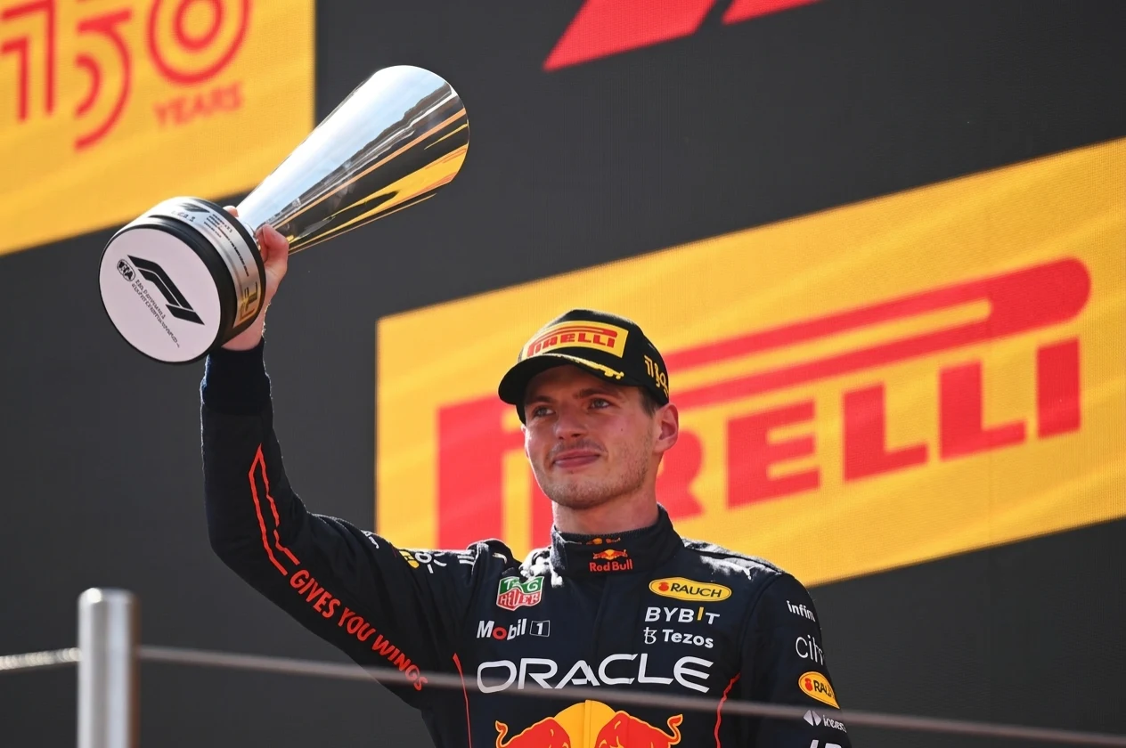 Formula 1 driver celebrating on podium at Grand Prix — race winner emotions