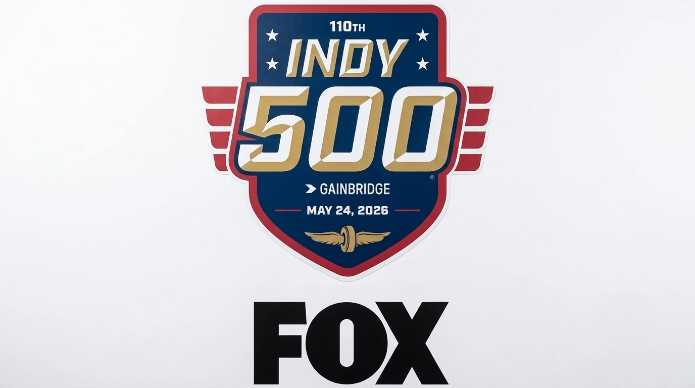 IndyCar pit lane during race broadcast — cameras and crew covering live action for FOX Sports television coverage