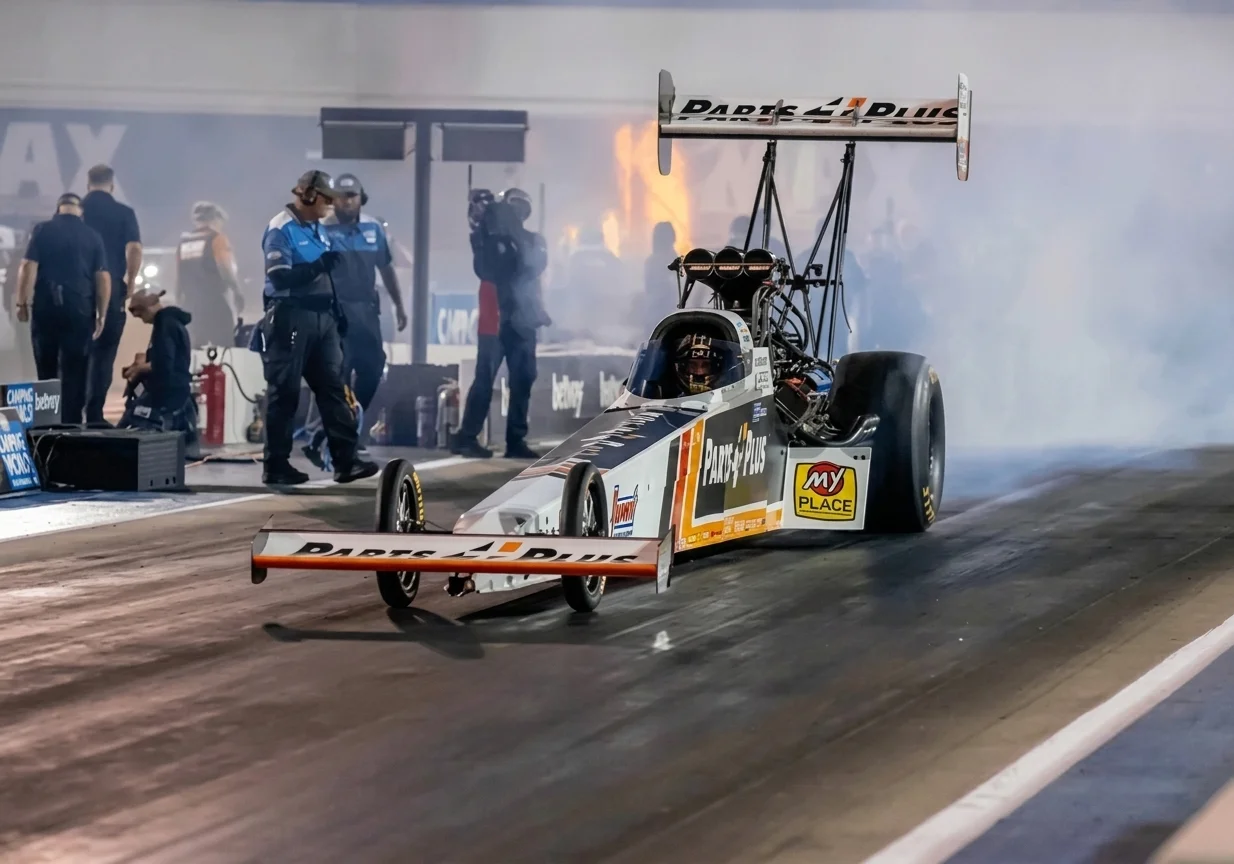 NHRA dragster launches from the starting line in fire and smoke at New England Dragway Epping NH