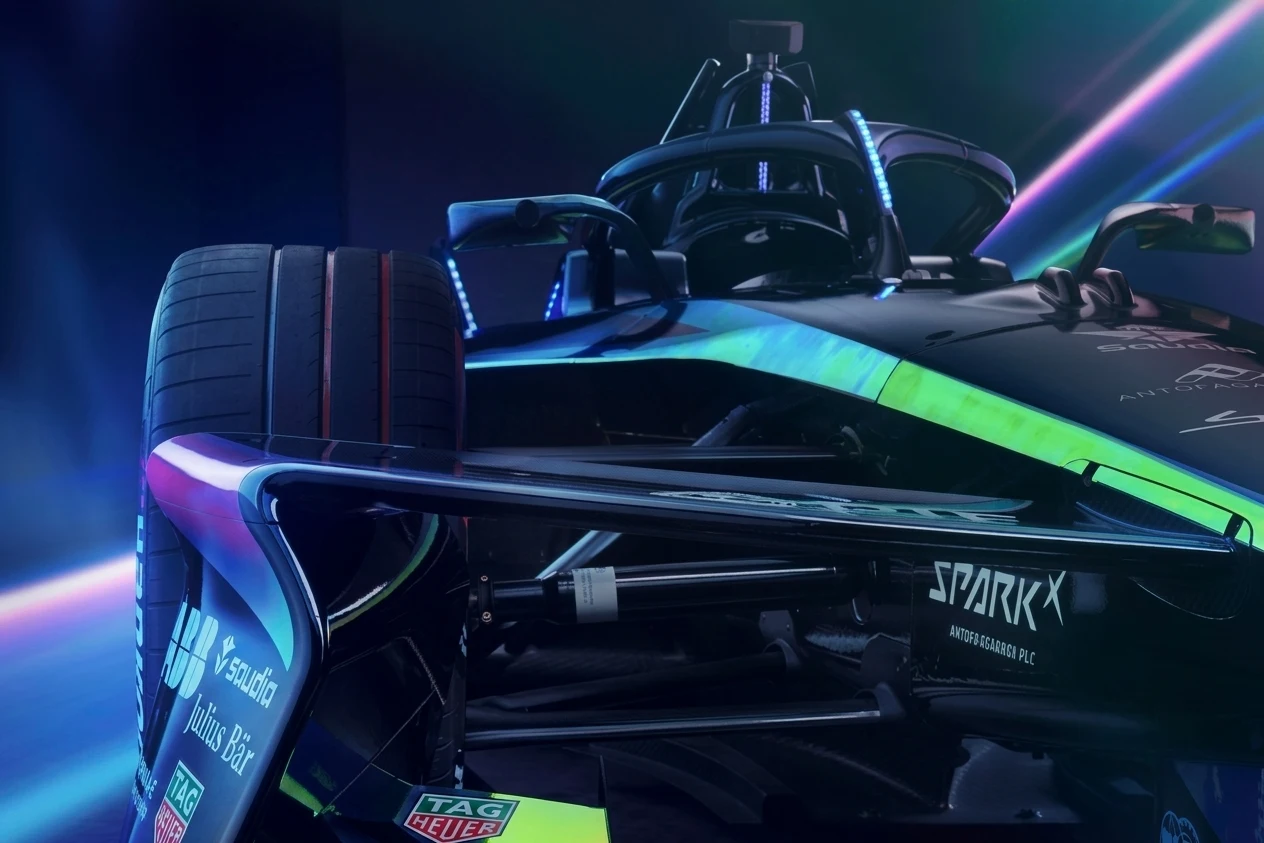 Electric Formula E race car cornering on street circuit showing aerodynamic bodywork and racing livery