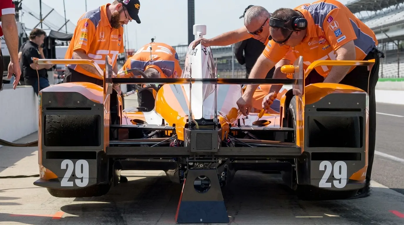 IndyCar race engineer reviewing data on pit wall during Indy 500 practice β race trim, tow speed and no-tow analysis on opening day at Indianapolis Motor Speedway 2026