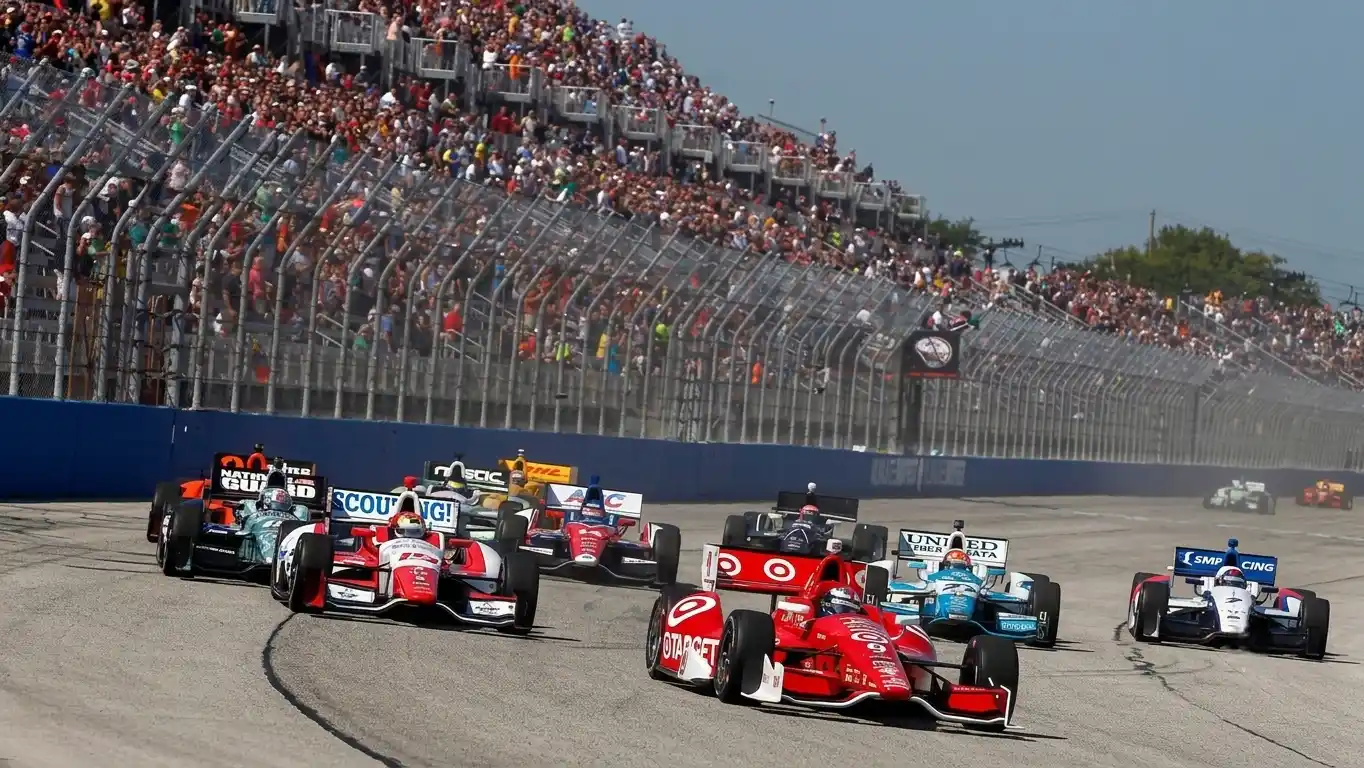 IndyCar open-wheel racing cars at speed — Road America 2026 NTT IndyCar Series Elkhart Lake Wisconsin