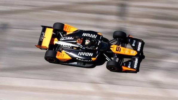 IndyCar race car holding position on road course during closing laps of a championship points race