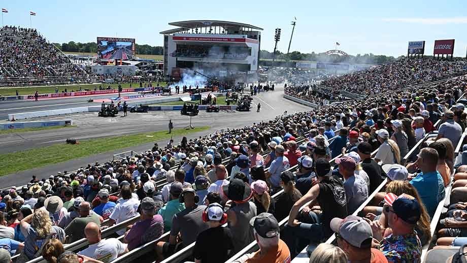 NHRA drag racing crowd at a national event grandstand — the packed atmosphere at Summit Motorsports Park Norwalk Ohio