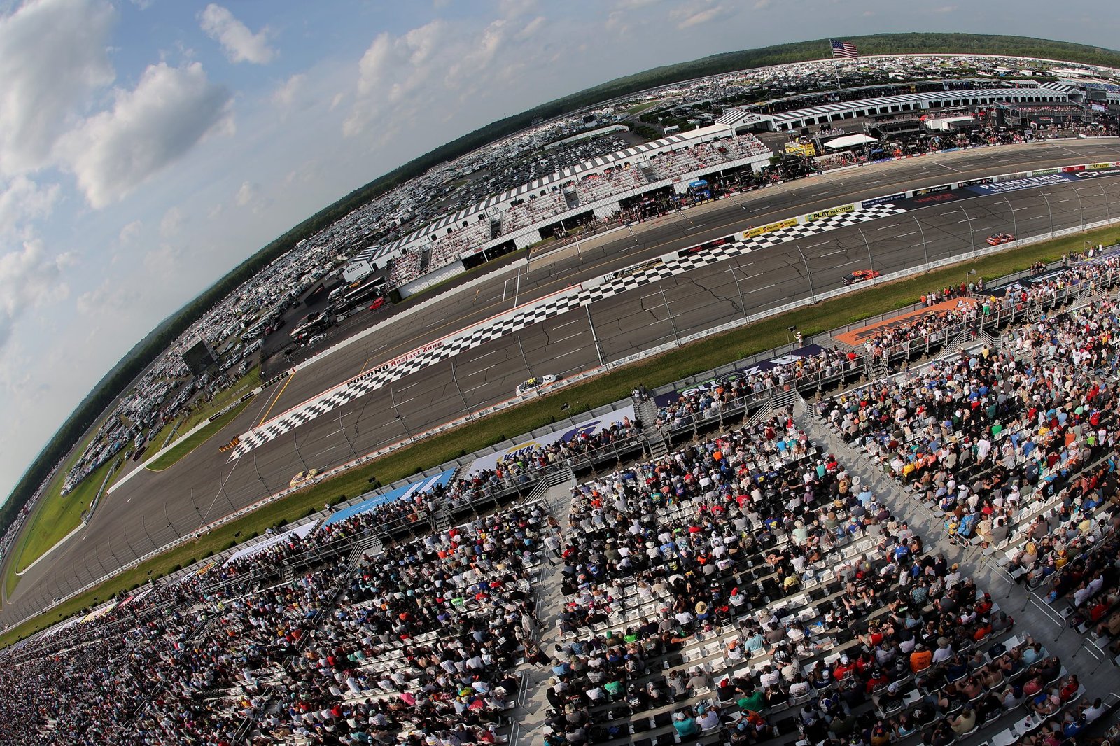 NASCAR race day atmosphere at packed grandstands oval track — Great American Getaway 400 Pocono 2026 crowd