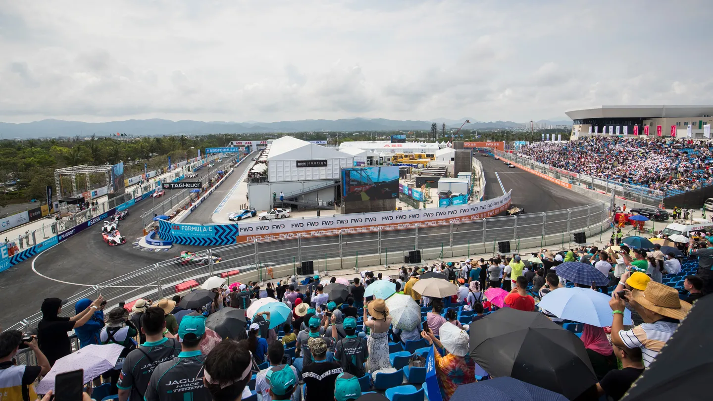 Formula E racing car on circuit with crowd in background — championship season action