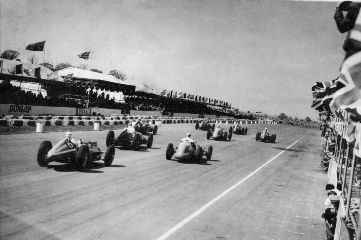 Historic racing cars on track representing the long history of Formula 1 at Silverstone British Grand Prix