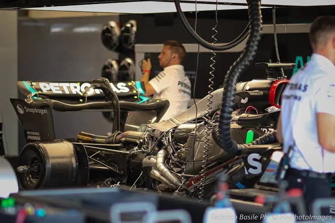 Formula 1 car at high speed on a forest circuit straight — representing Belgian Grand Prix 2026 championship battle at Spa