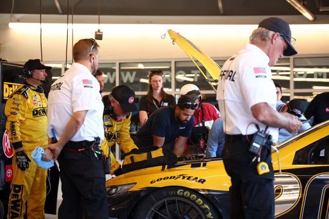 NASCAR garage area with cars being prepared — the 2027 driver market will reshape several Cup Series lineups