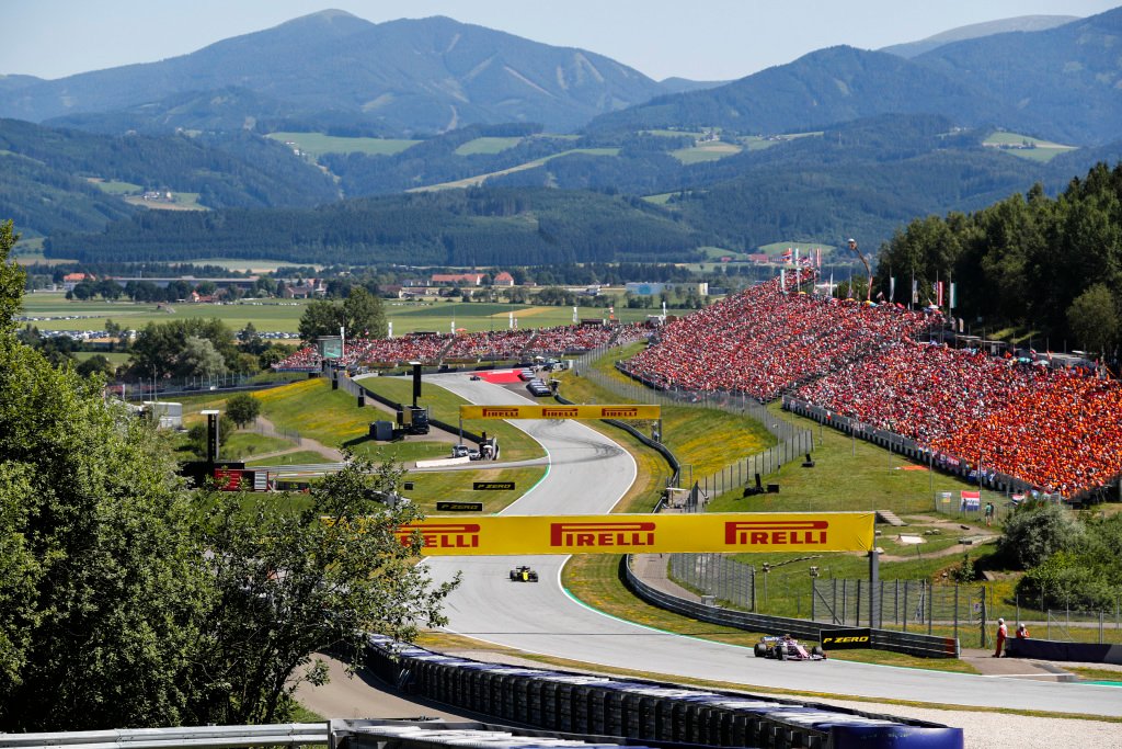 Red Bull Ring grandstands packed with fans during the Austrian Grand Prix 2026 — Spielberg Styrian hills backdrop