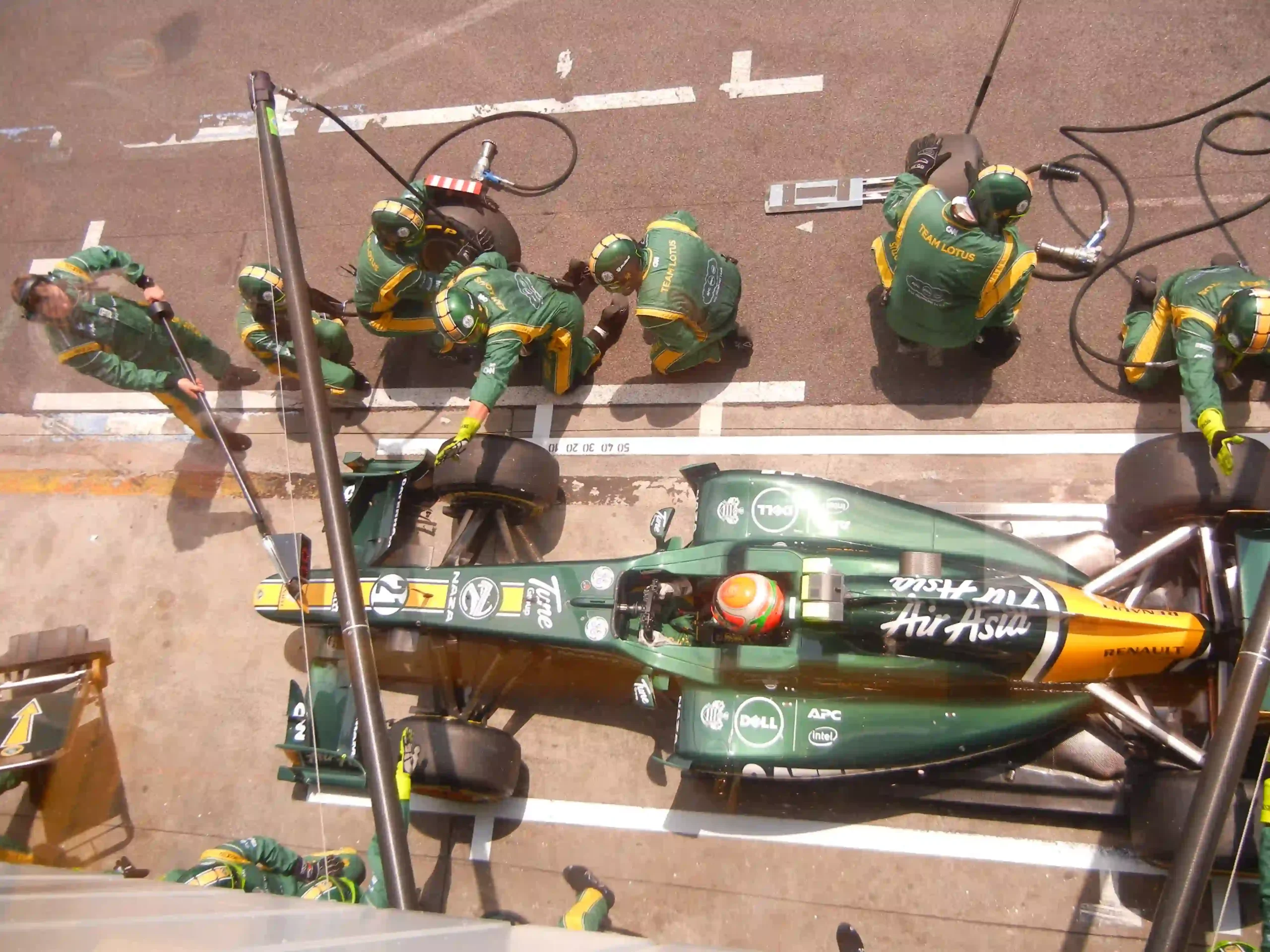 Team Lotus Formula 1 car being serviced during the 2011 Brazilian Grand Prix