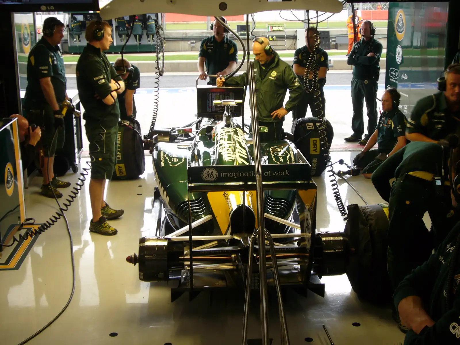 Team Lotus Formula 1 mechanics working in the garage during the 2011 British Grand Prix