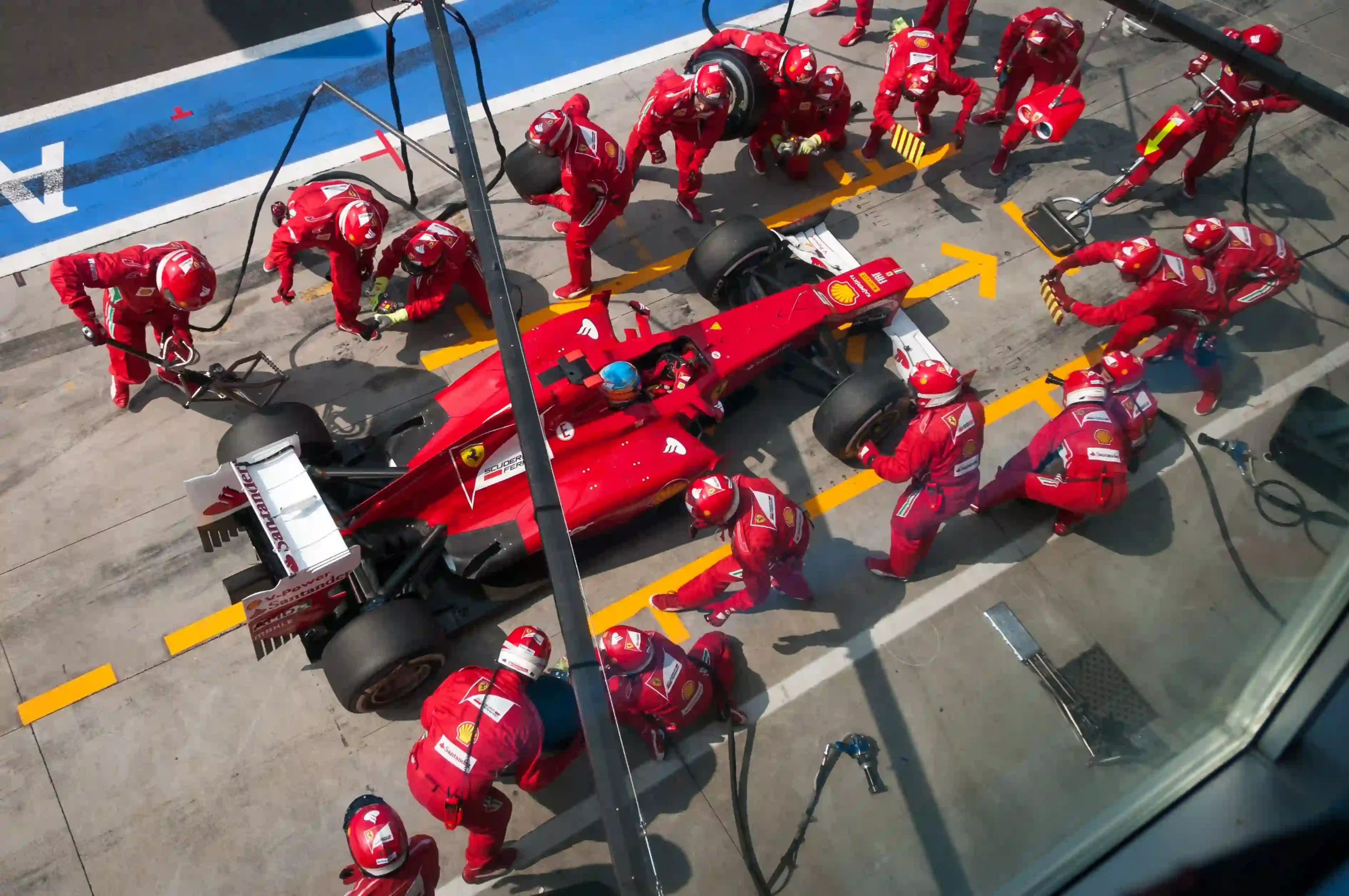 Ferrari Formula 1 pit crew servicing Fernando Alonso at the 2012 Italian Grand Prix