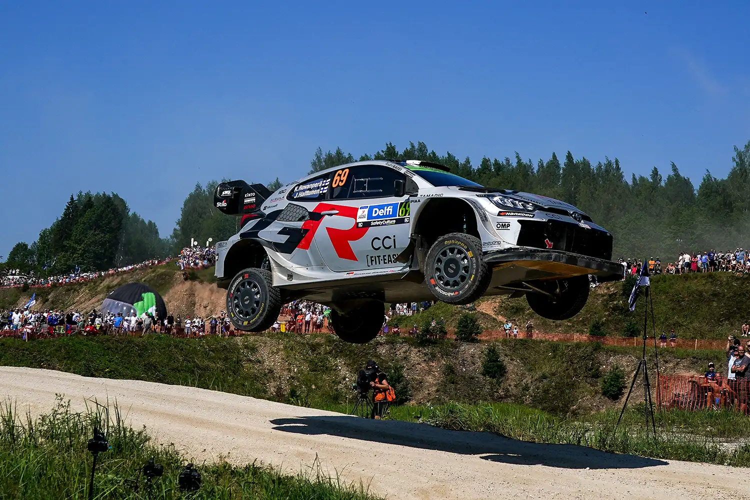 Toyota GR Yaris Rally1 airborne over a gravel jump during WRC Rally Estonia