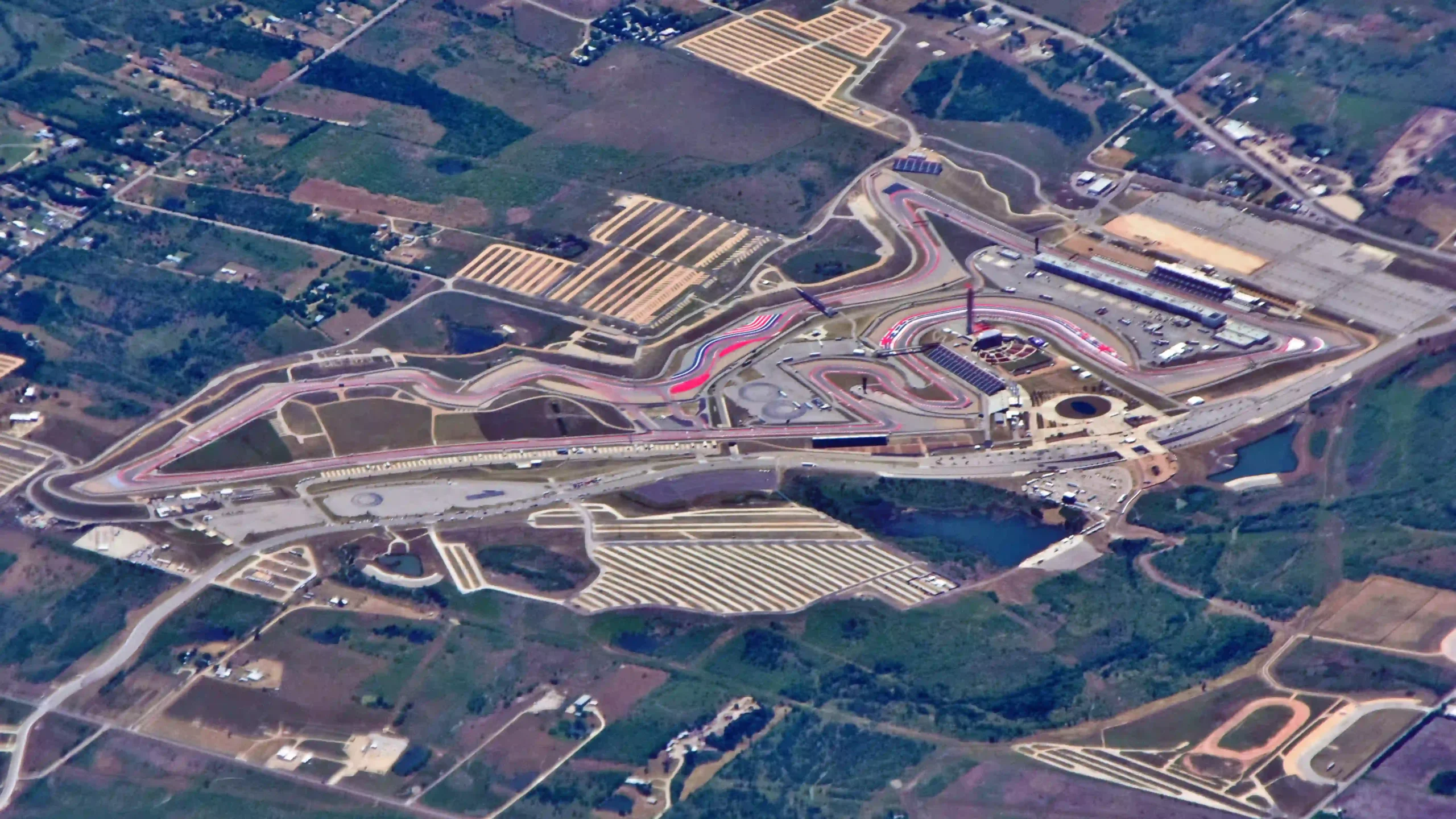 Aerial view of the Circuit of the Americas showing wide asphalt runoff and circuit boundaries