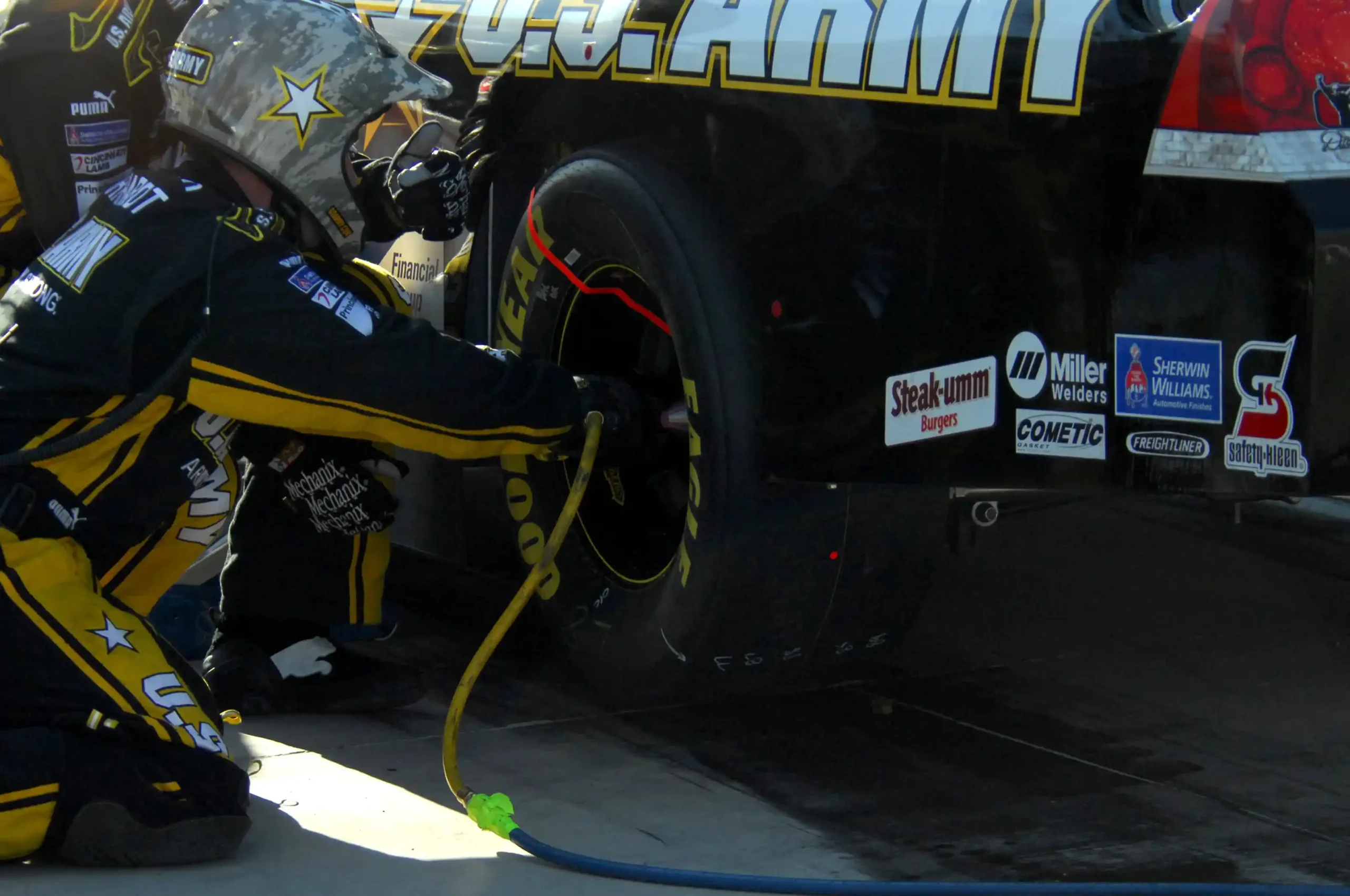 Close view of a NASCAR rear tire changer using a five-lug impact gun during a 2008 pit stop