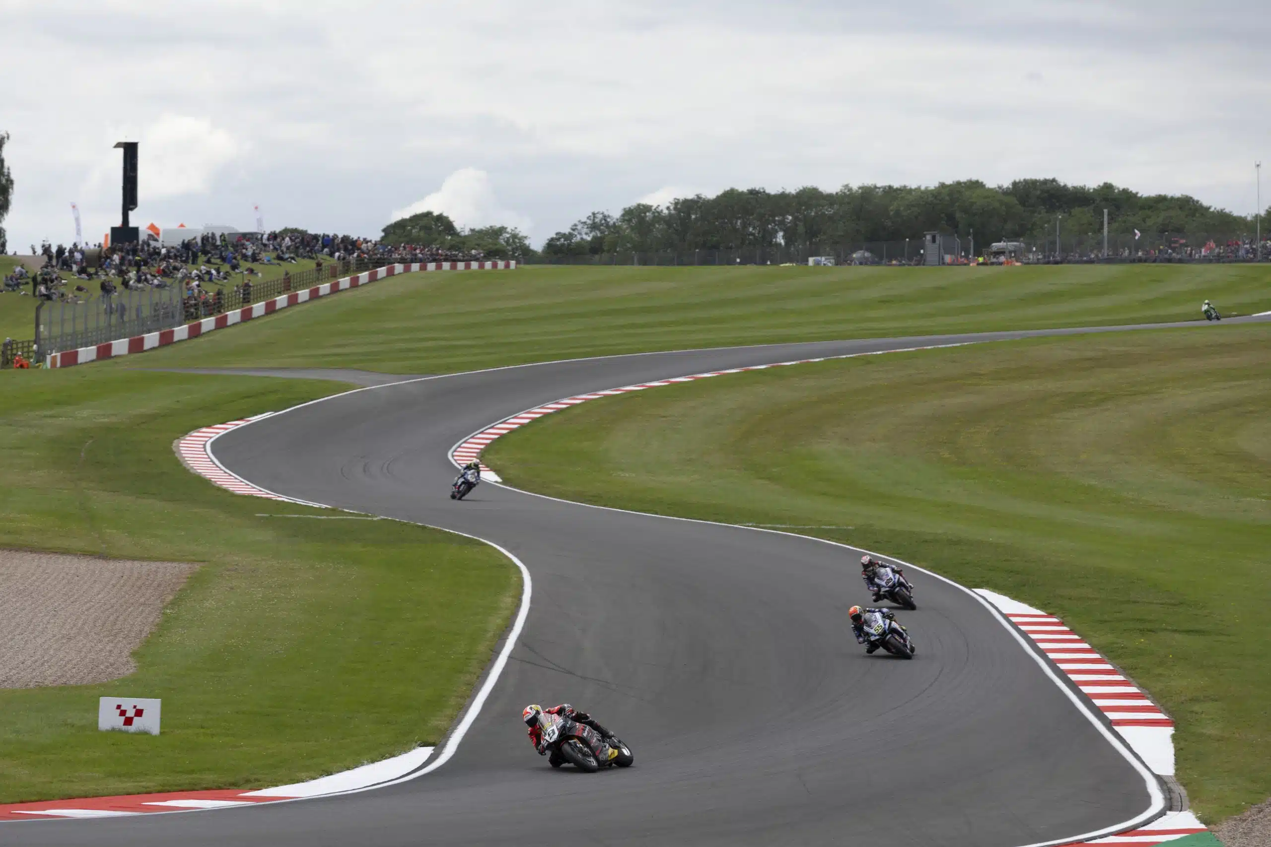 Motorcycle racing at high speed on a flowing road circuit — WorldSBK championship contenders preview Donington Park 2026