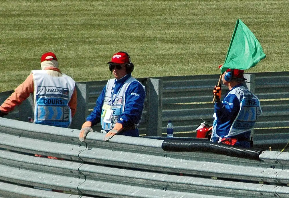 Formula 1 marshal waving a green flag at the 2005 United States Grand Prix