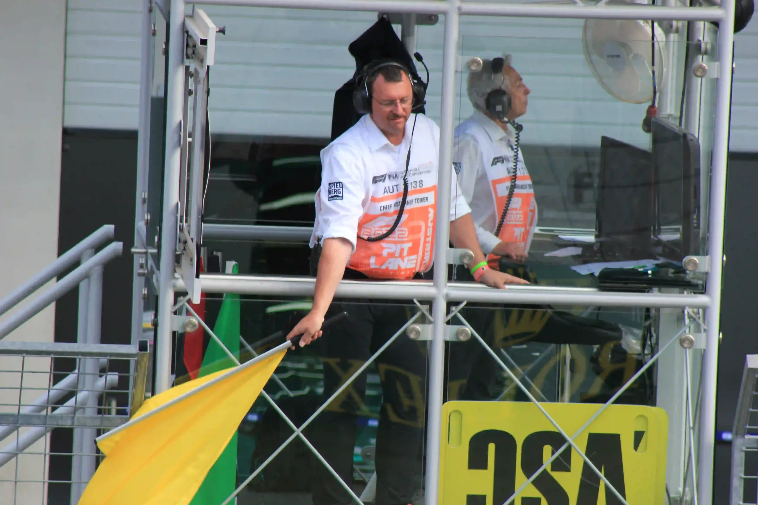 Formula 1 marshal waving a yellow flag at the 2022 Austrian Grand Prix