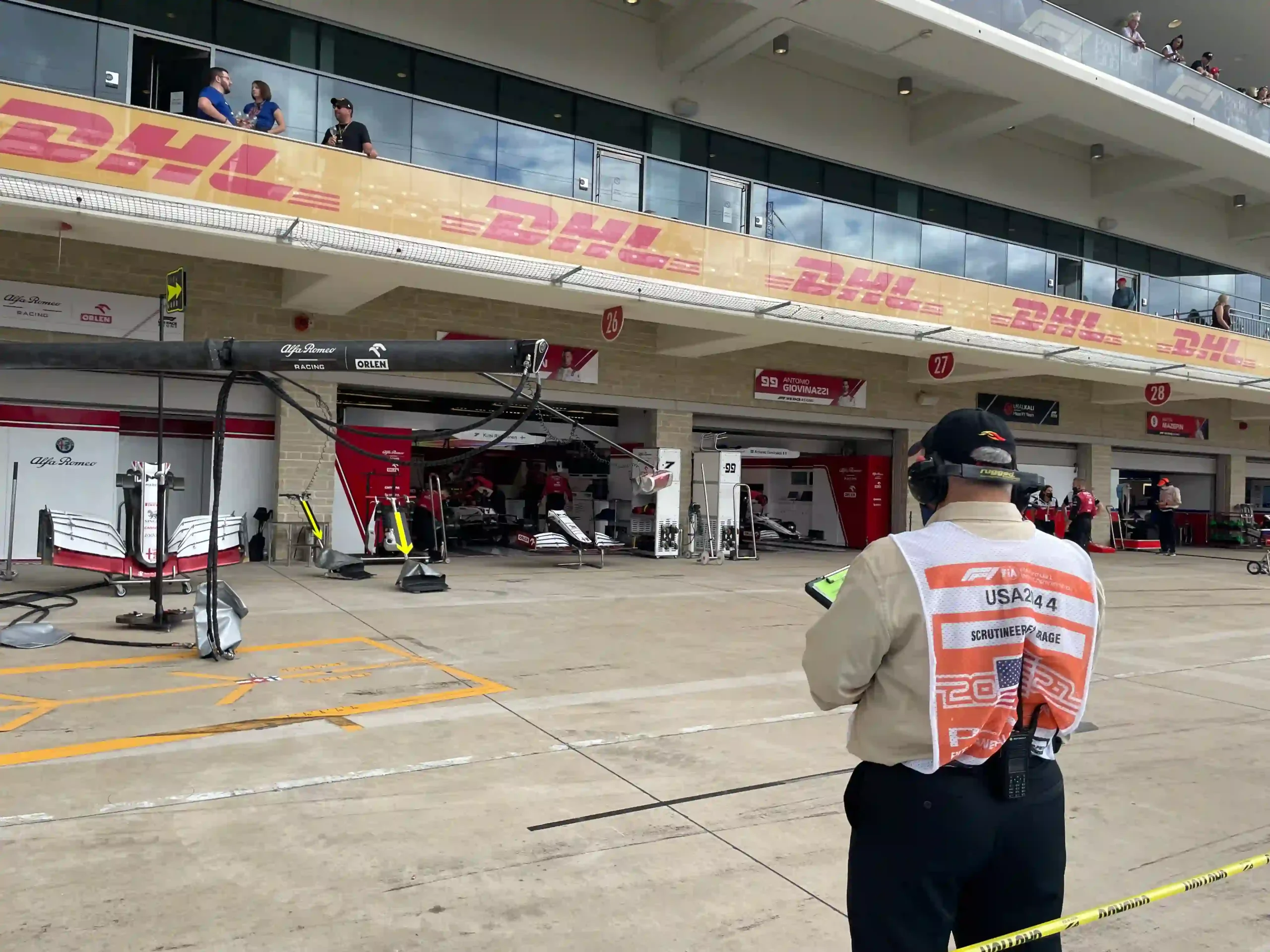 FIA scrutineer observing the Alfa Romeo Formula 1 garage at the 2021 United States Grand Prix