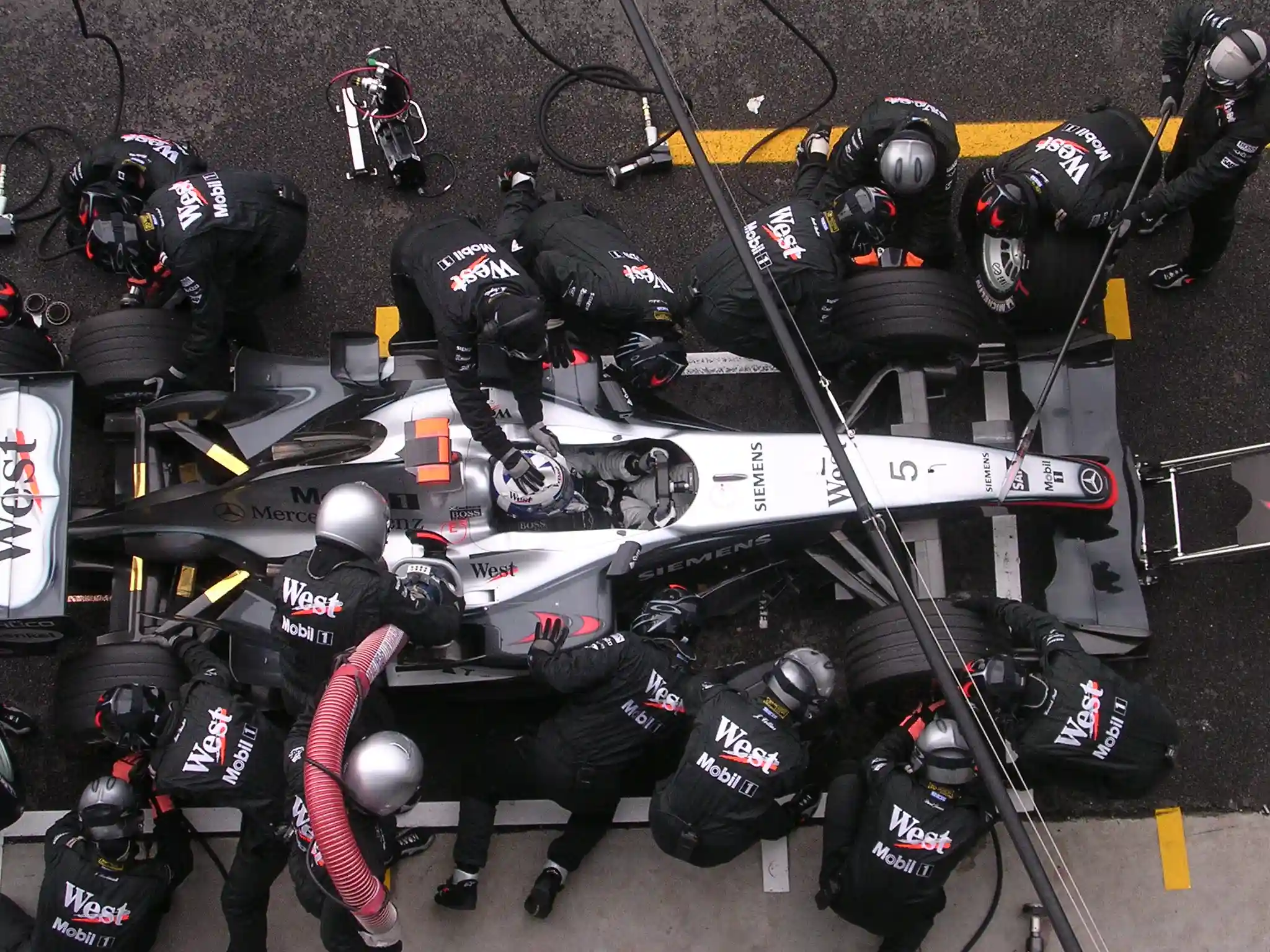 McLaren Formula 1 car being refuelled and serviced during the 2004 Italian Grand Prix