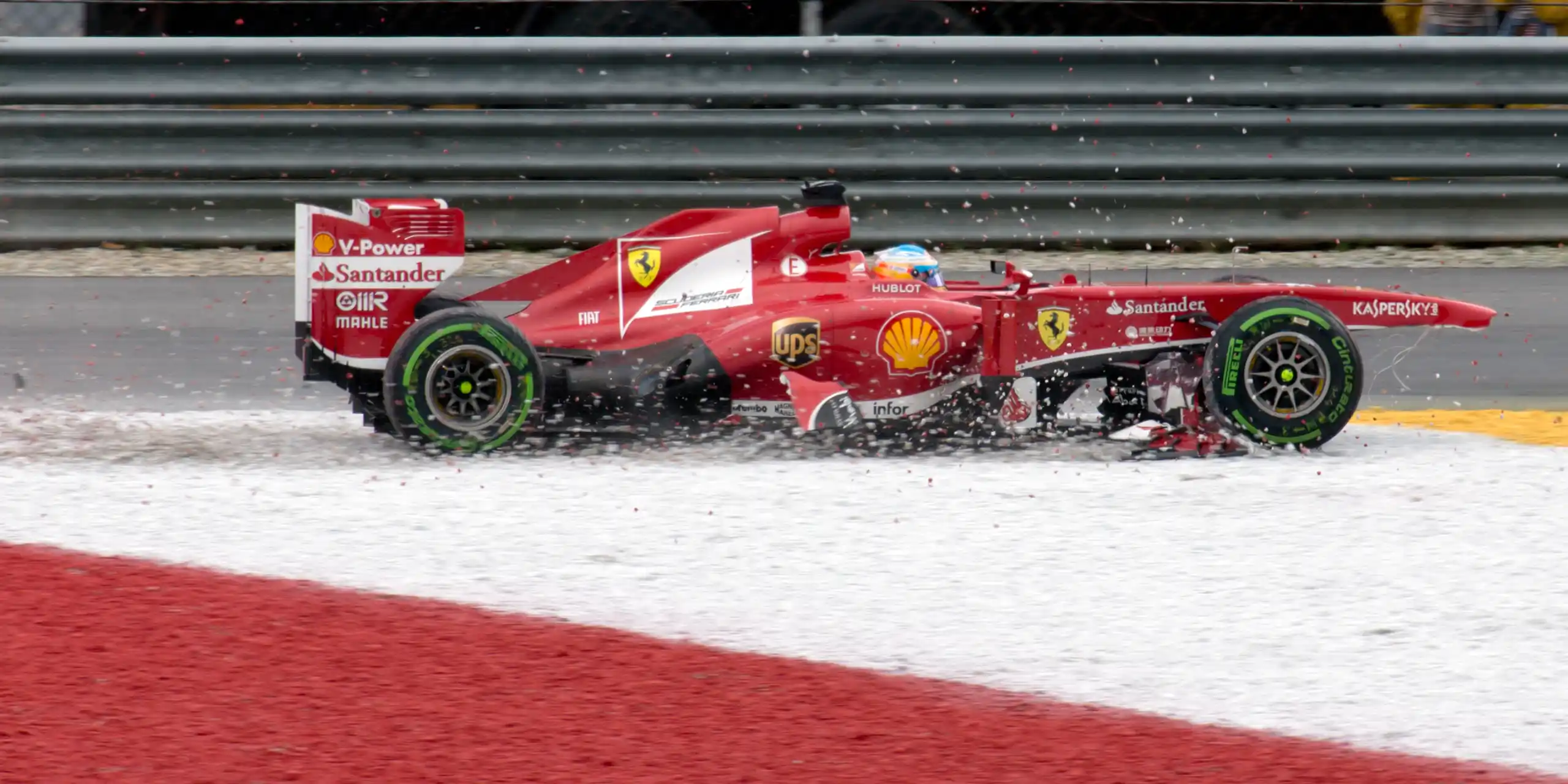 Formula 1 car crossing a gravel trap during the 2013 Malaysian Grand Prix