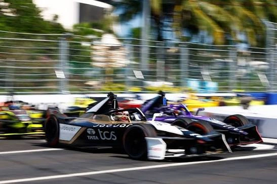 Formula E Gen3 Evo car under tropical lighting at a street circuit, energy harvesting through braking zone