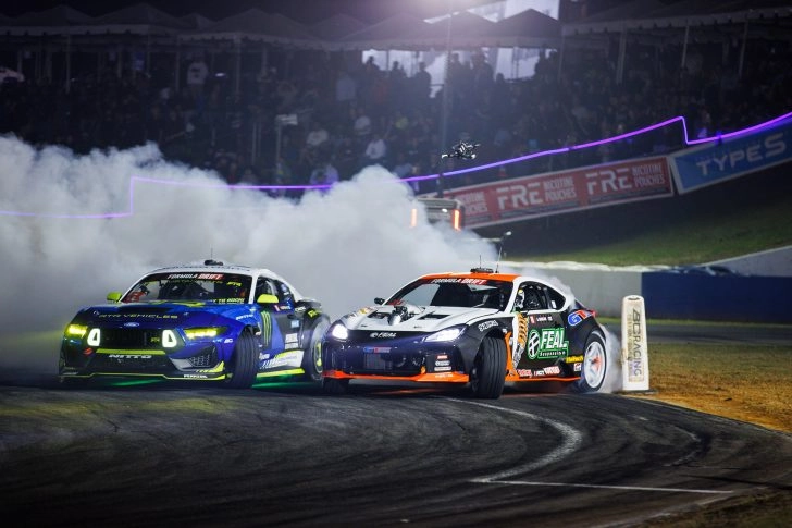 Vaughn Gittin Jr and Aurimas Bakchis drifting in close tandem during the 2026 Formula DRIFT Atlanta event