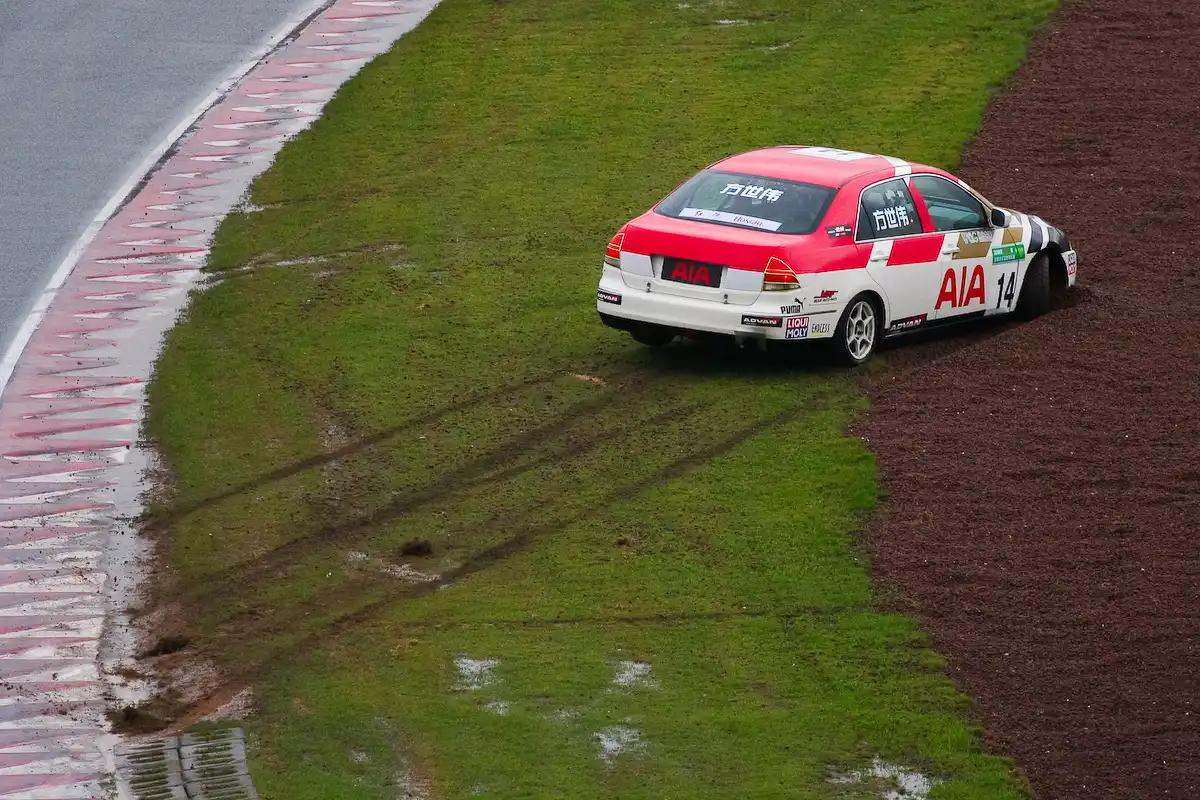 Race car stopped in a gravel trap after leaving the circuit