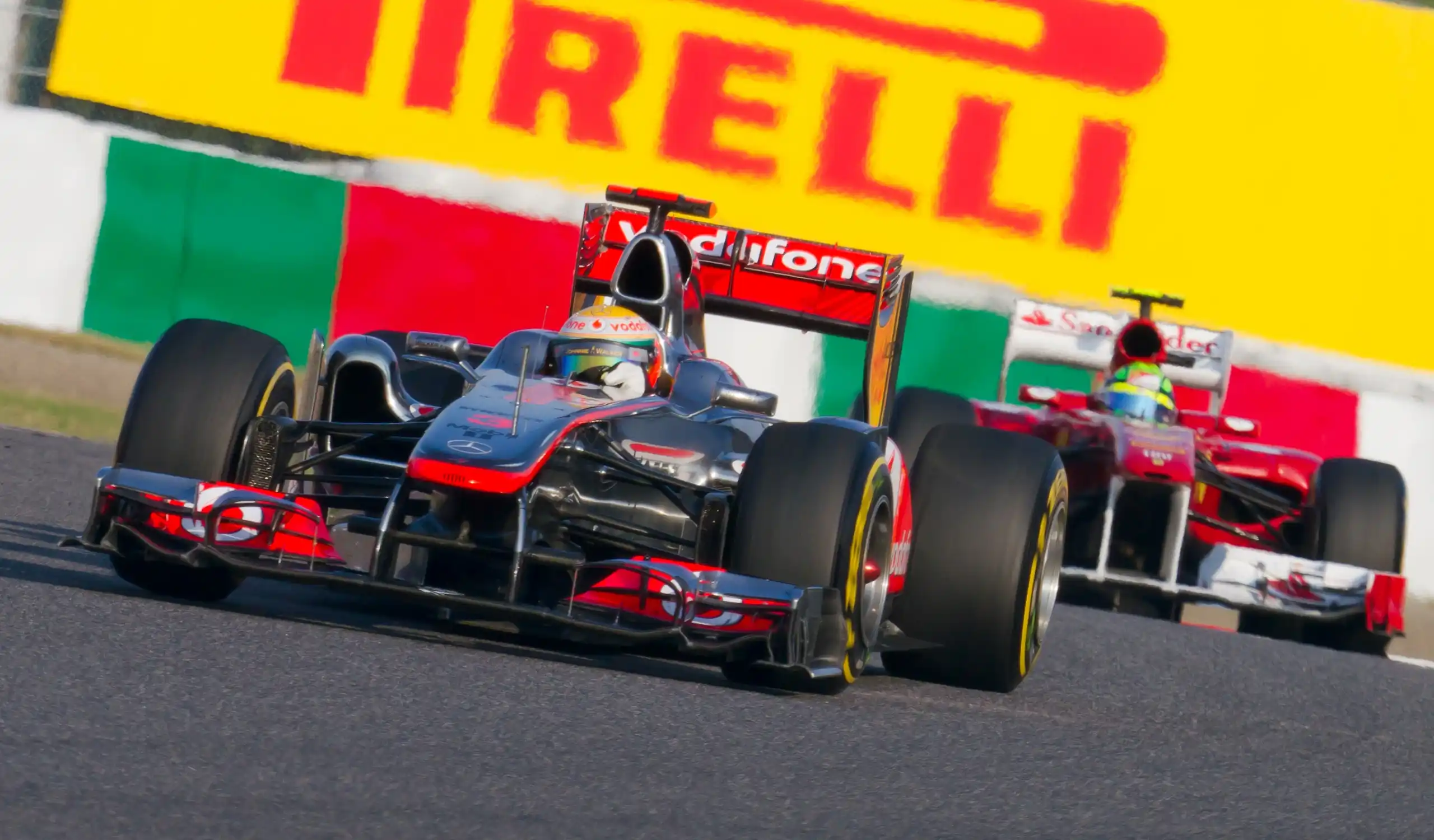 Lewis Hamilton and Felipe Massa racing closely during the 2011 Japanese Grand Prix
