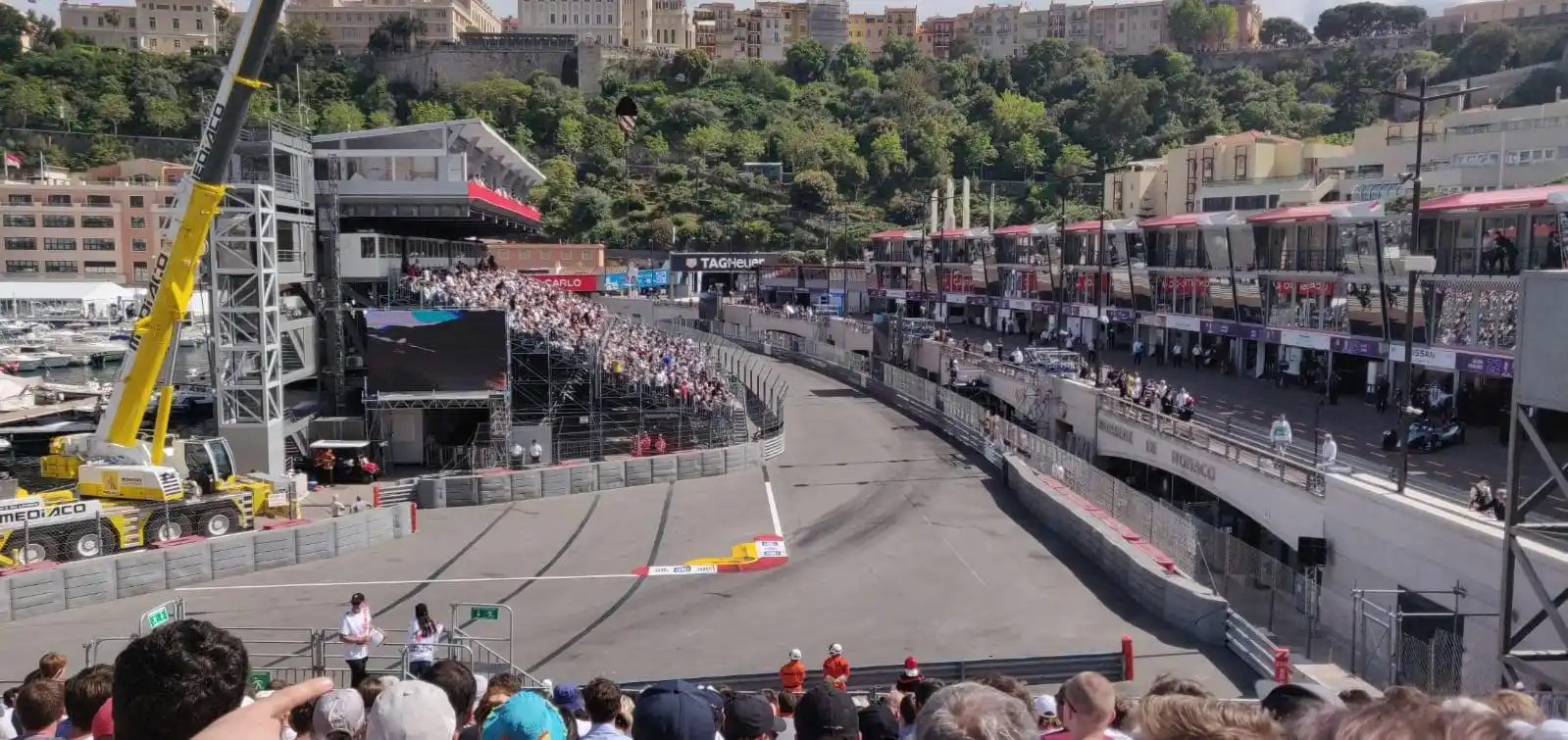 Tight Monaco street-circuit corner with barriers close to the racing surface