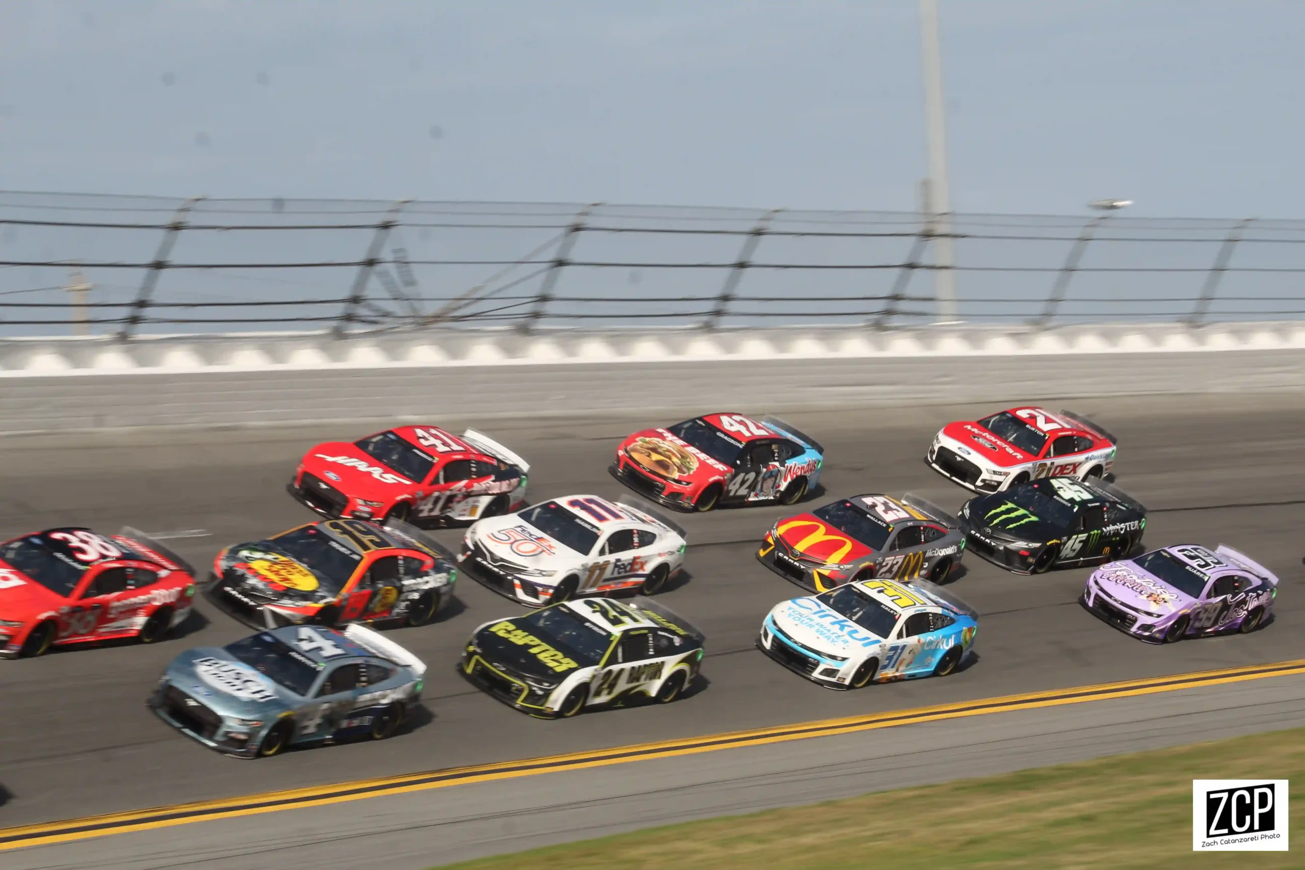 NASCAR Cup Series cars racing in a tight pack during the 2023 Daytona 500
