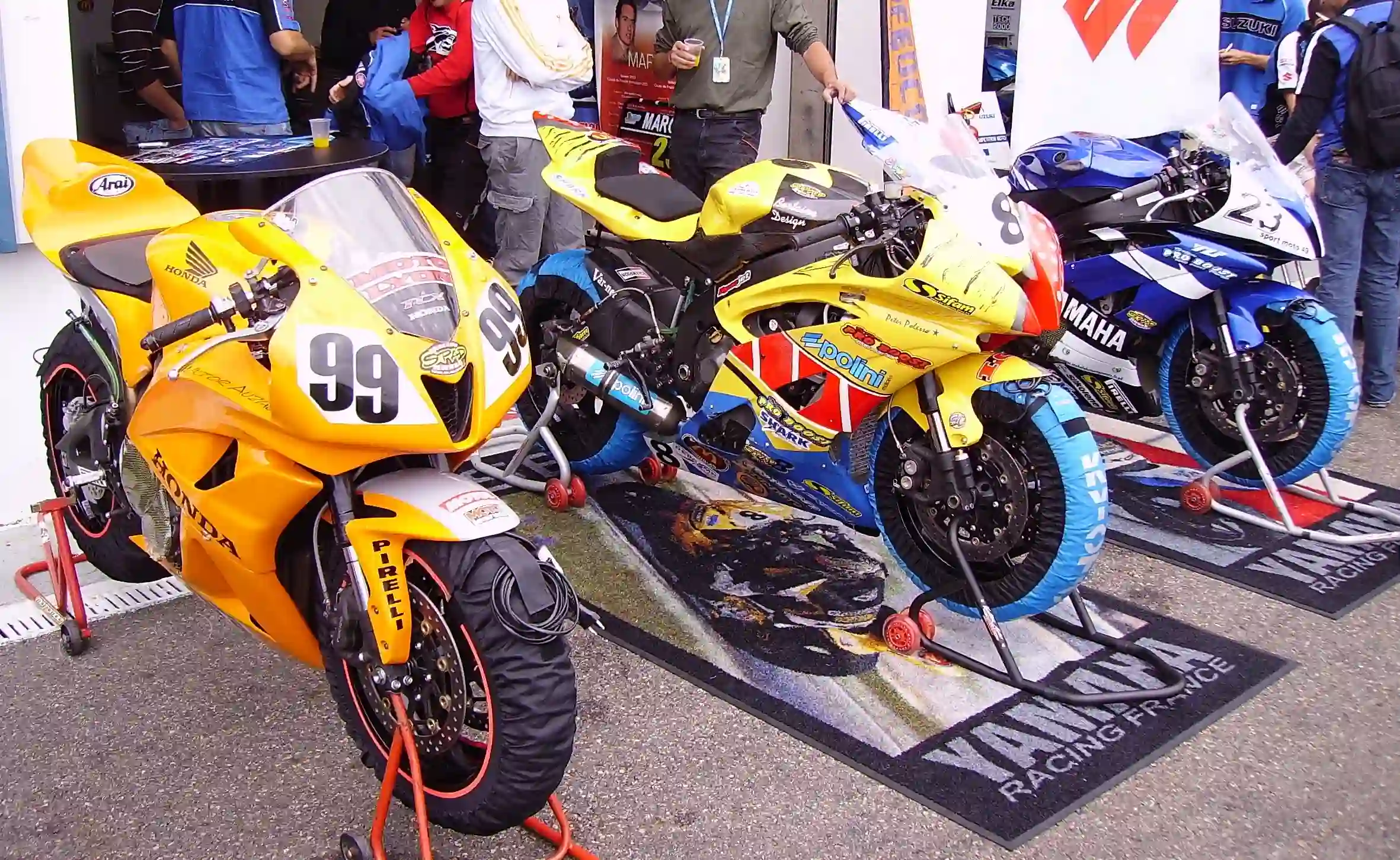 Honda and Yamaha racing motorcycles lined up at Magny-Cours during a 2009 French Superbike weekend