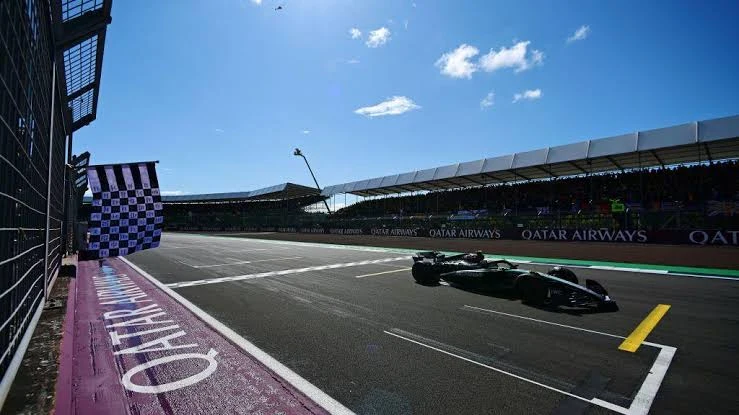 Formula racing car interior cockpit view at speed on a high-speed British circuit during qualifying