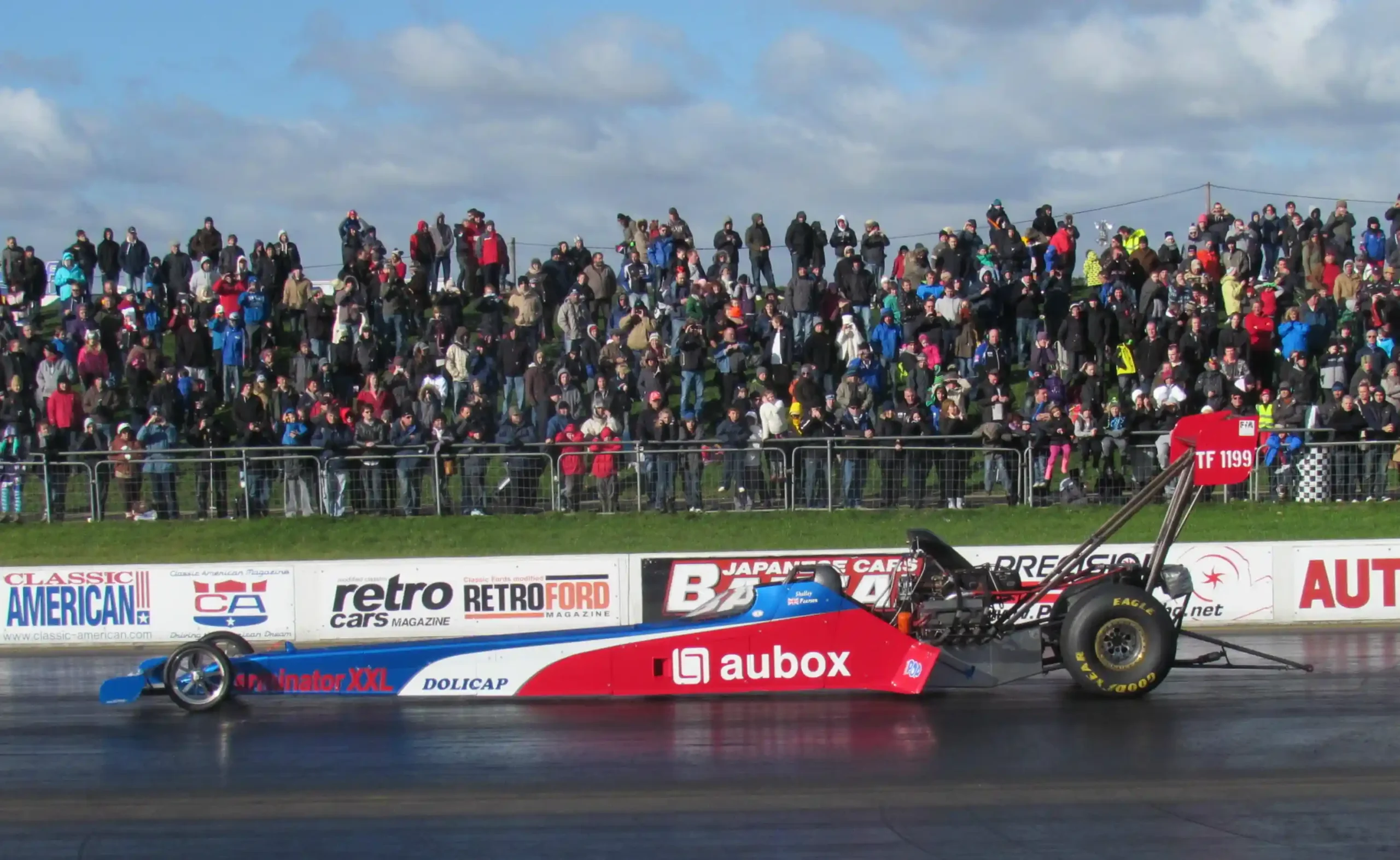 Top Fuel dragster at Santa Pod Raceway with exposed rear-mounted engine