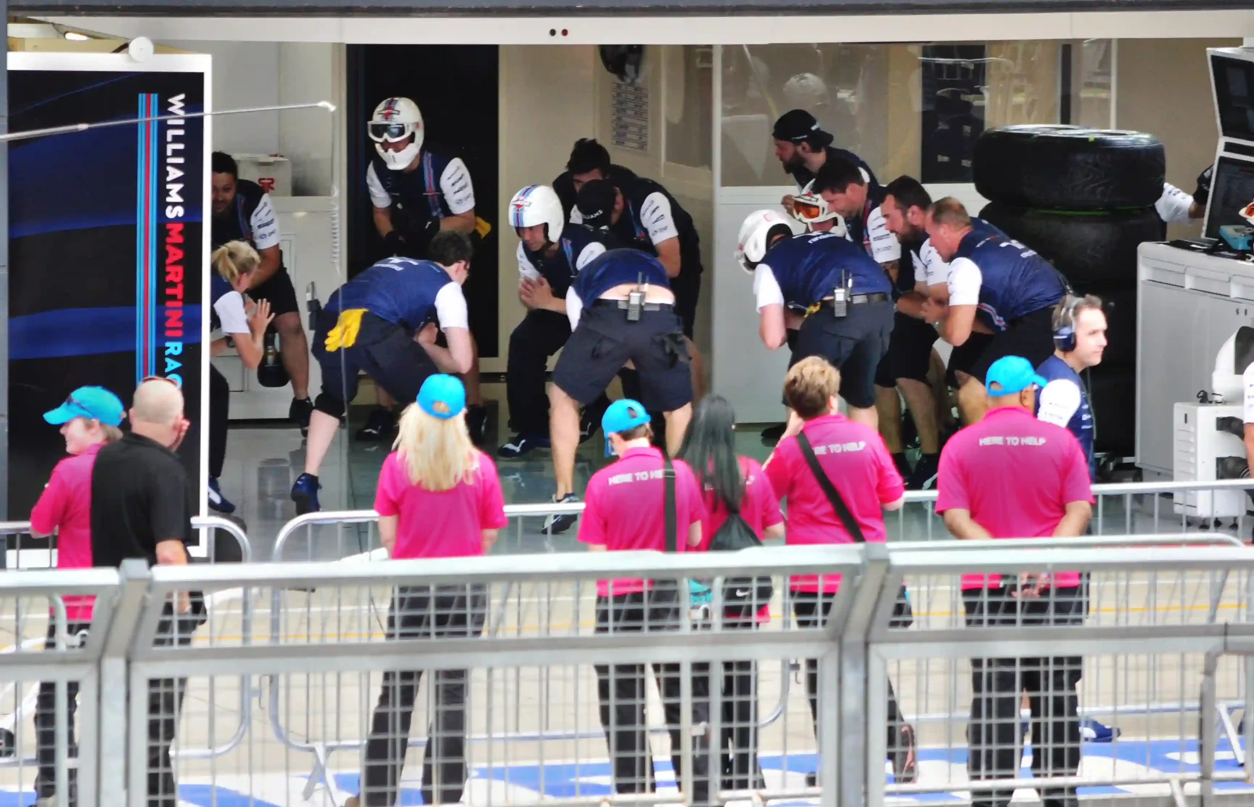 Williams Formula 1 pit crew completing a warm-up routine before pit stop practice