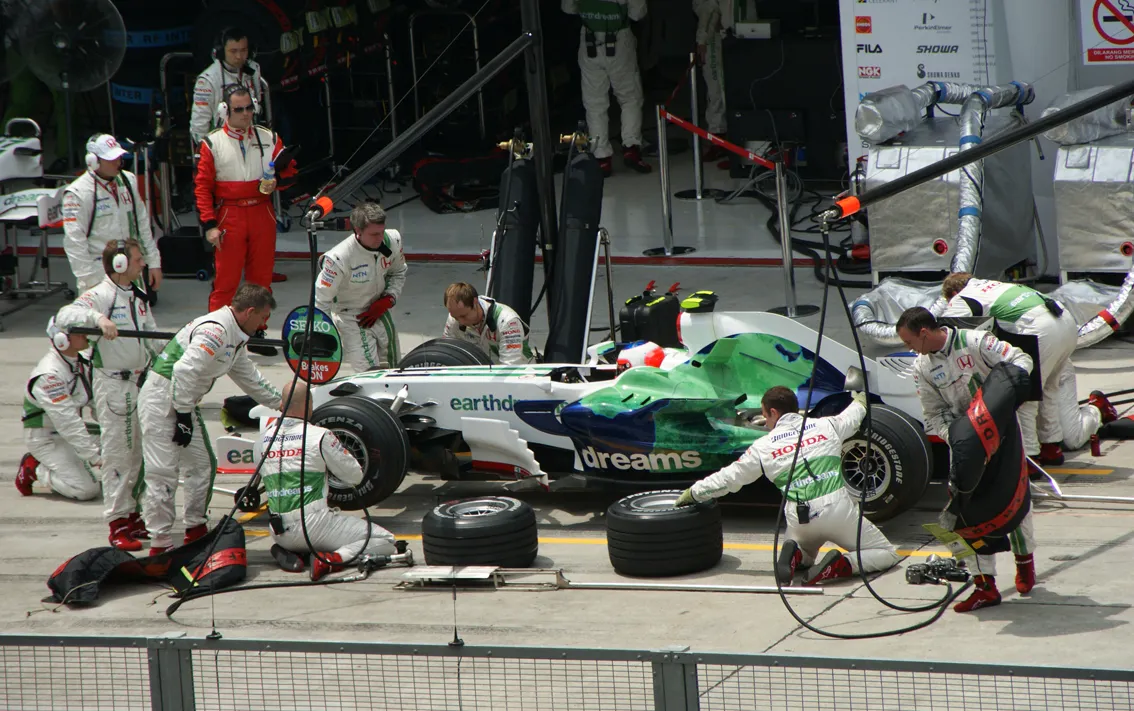 Honda Formula 1 pit crew servicing Rubens Barrichello during the 2008 Malaysian Grand Prix