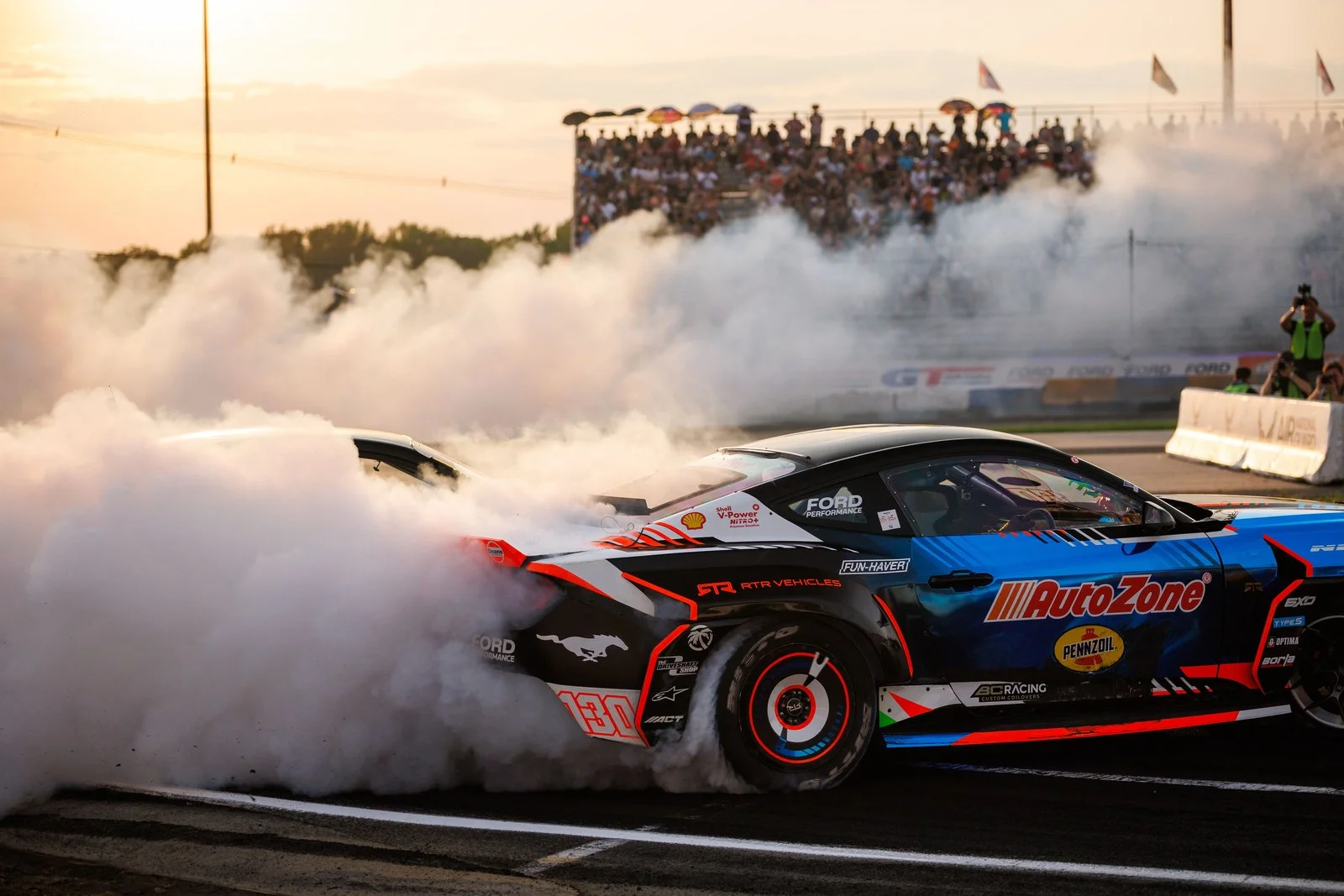 James Deane drifts the Ford Mustang RTR through heavy tire smoke in Formula DRIFT competition