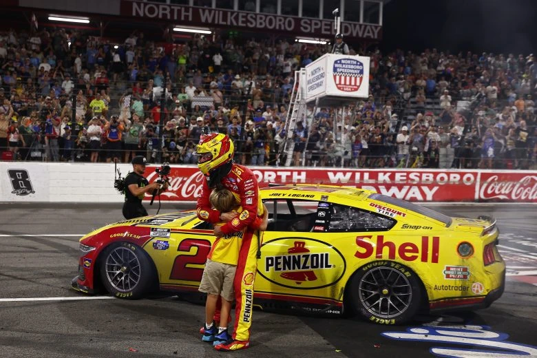 Joey Logano embraces his son Hudson after winning at North Wilkesboro Speedway