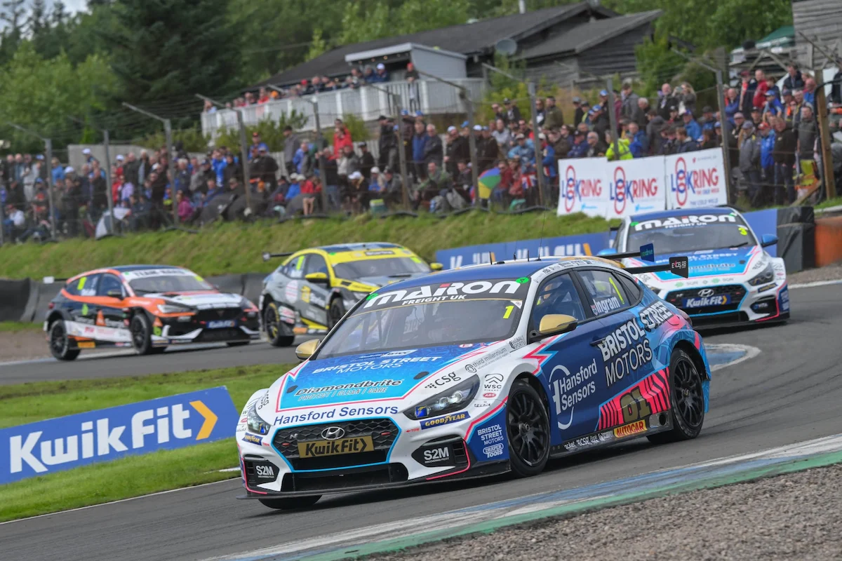 BTCC cars racing through the Knockhill hairpin in Scotland