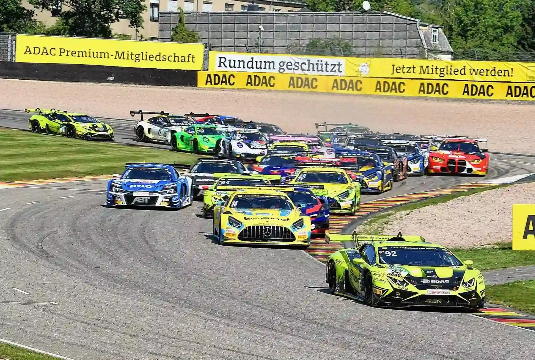 DTM field racing at Sachsenring with spectators