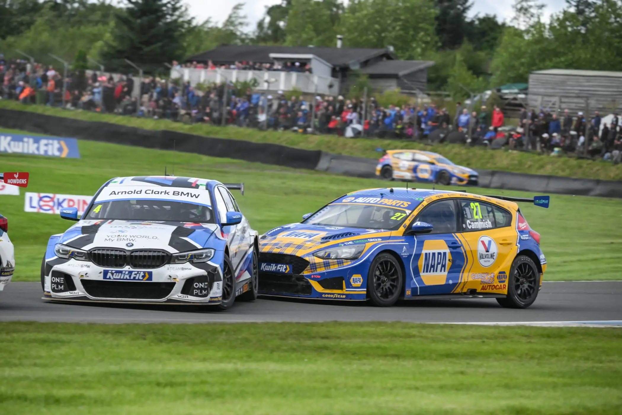 NAPA Ford and BMW touring cars racing side by side at Knockhill