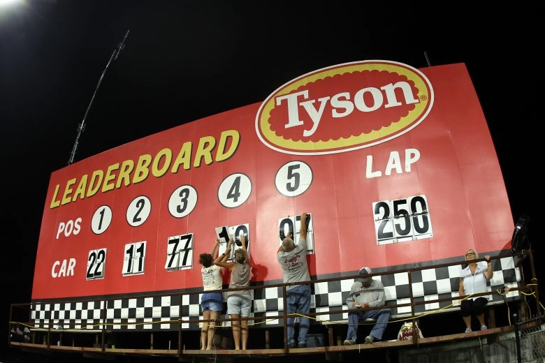 North Wilkesboro Speedway workers update the manual top-five scoreboard during the Window World 450
