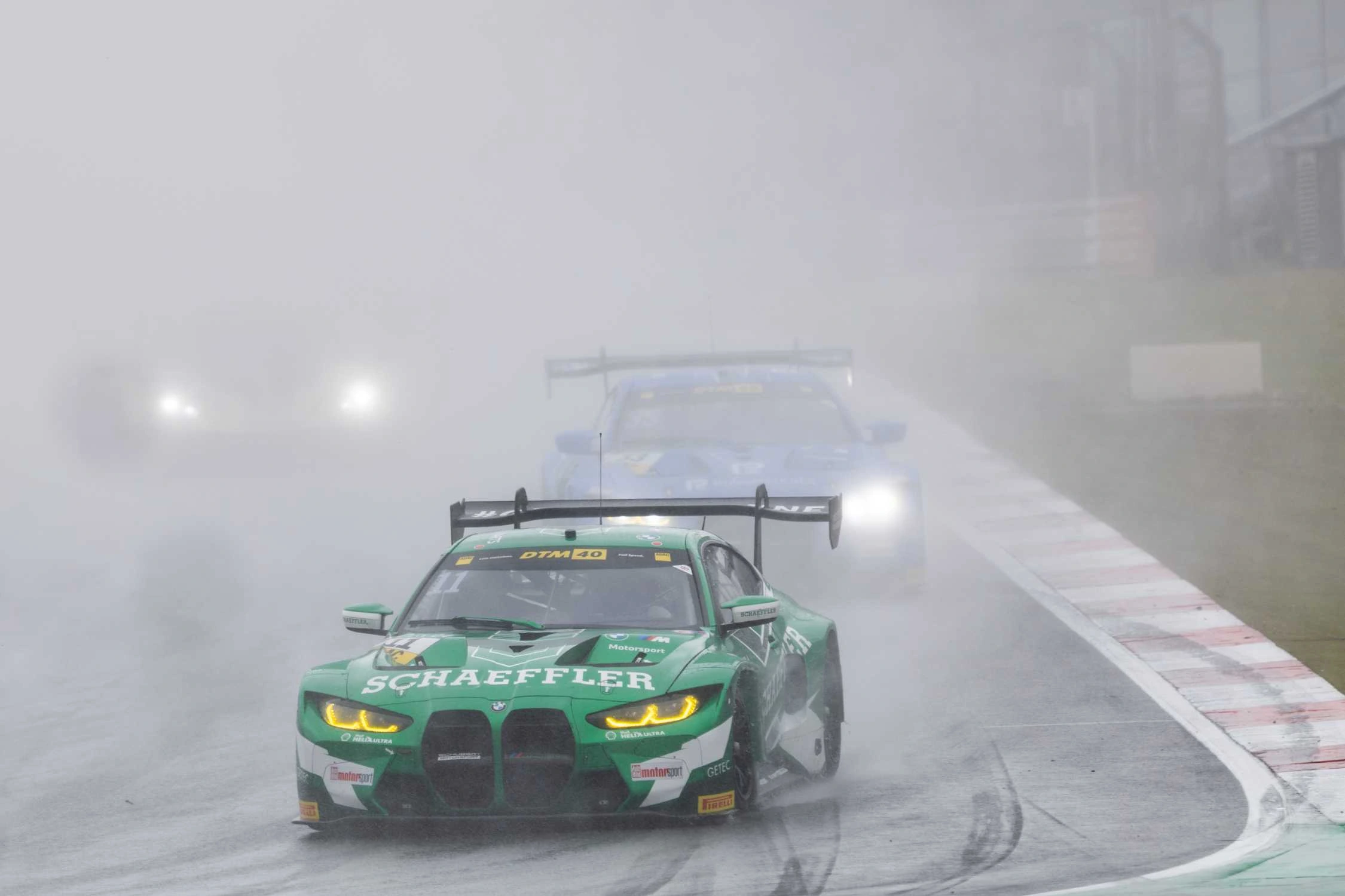 Marco Wittmann BMW M4 GT3 racing in heavy rain at the Nürburgring during DTM